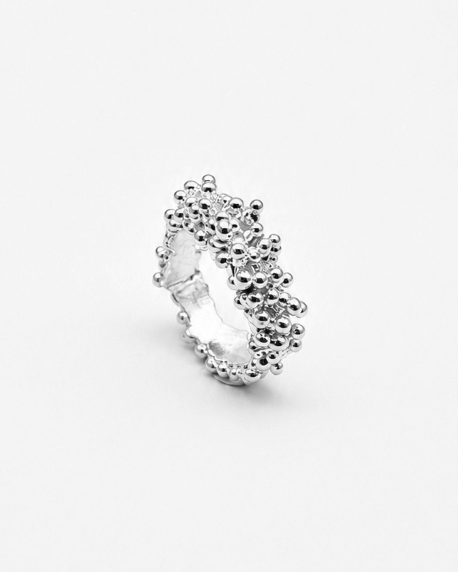 Magata textured silver ring with bubbly surface on white background