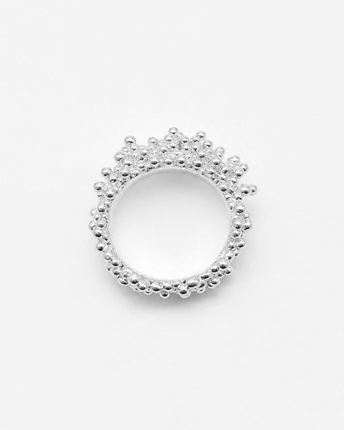 Silver ring with a beaded design on a white background