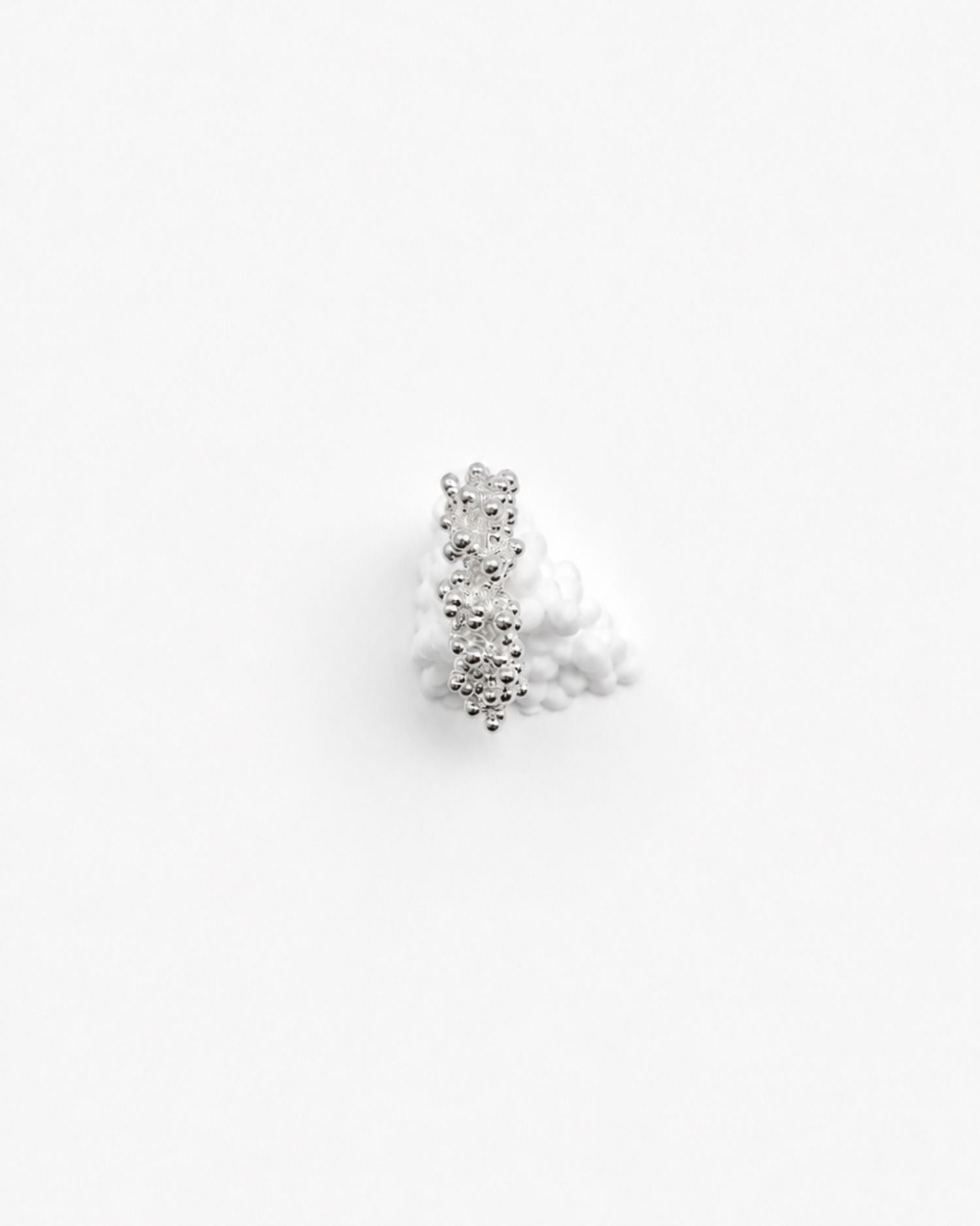 Magata textured silver ring with bubbly surface on white background