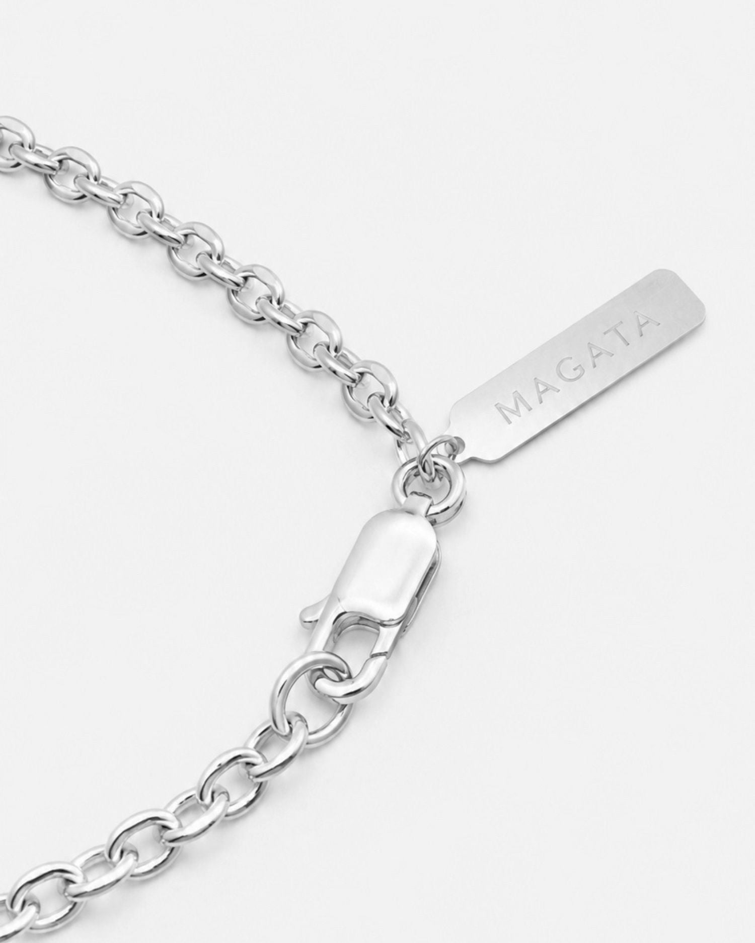 Silver chain bracelet with Magata logo tag on a white background