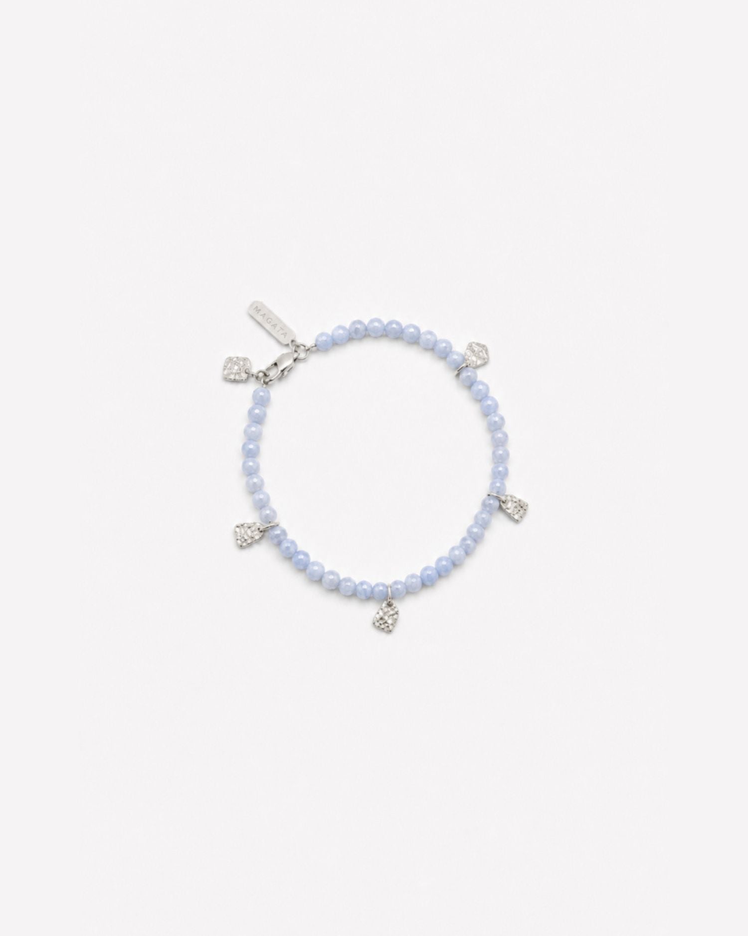 Blue chalcedony beaded anklet / bracelet with silver charms on a white background and Magata logo tag