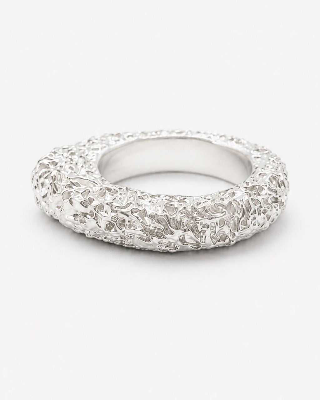 Silver ring with lava texture design on a white background