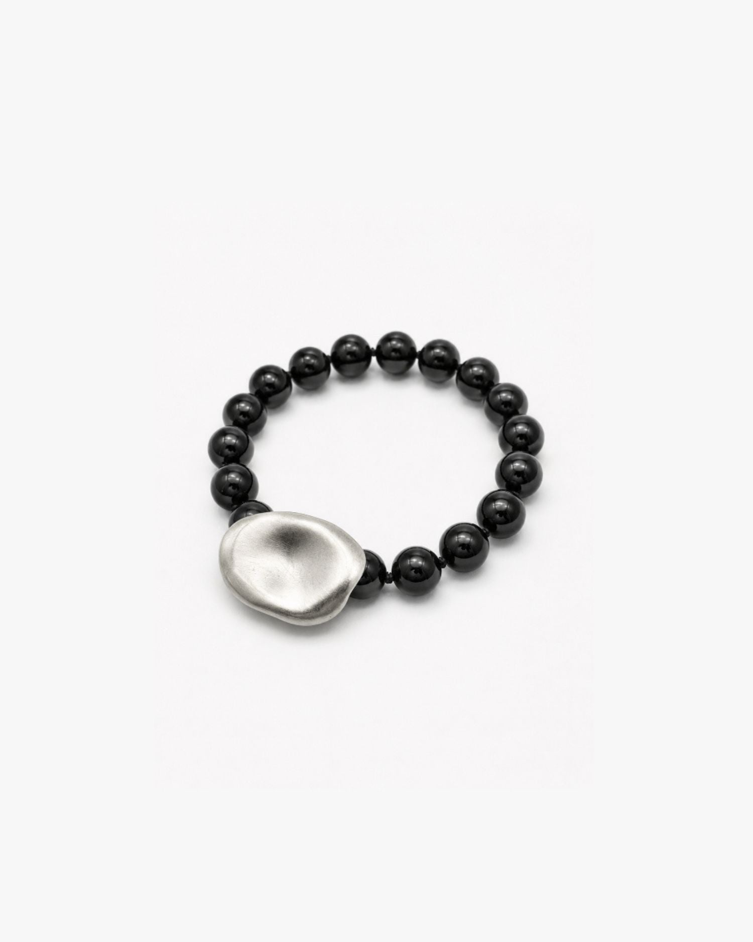 Black onyx beaded bracelet with a silver teardrop-shaped silver clasp on a white background